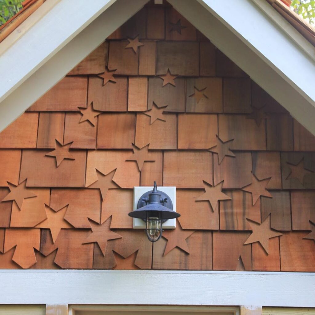 artistic cedar shingle siding on children’s playhouse with decorative details