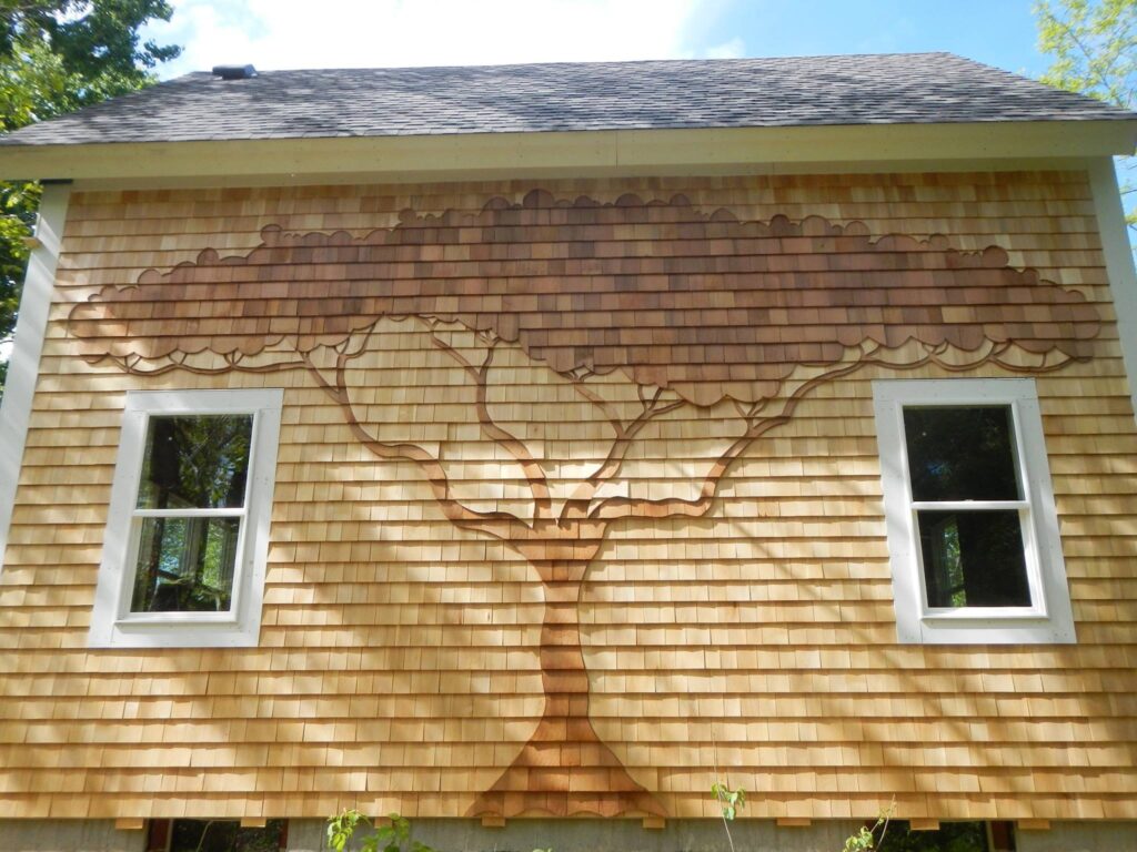 stylized tree motif crafted in cedar shingle siding by Roger Dumas