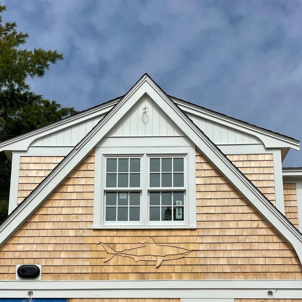 decorative shark relief carved into wood shingle siding