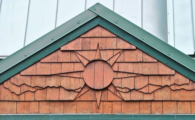 sunburst design in layered cedar shingles on home gable
