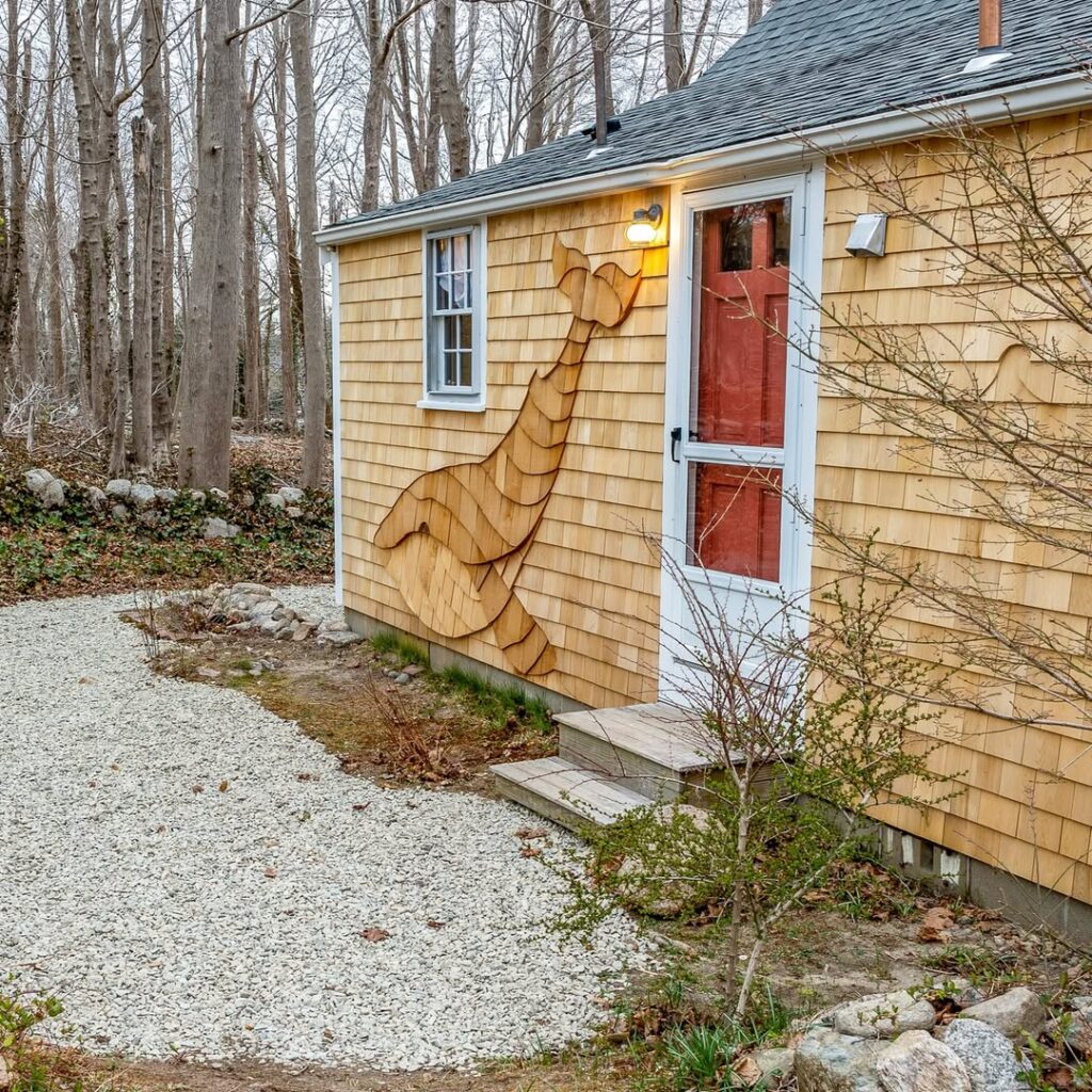 handcrafted whale design in cedar shingle siding on coastal home