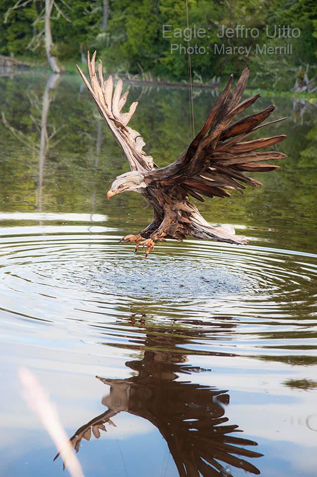 Eagle flying over the water made from driftwood