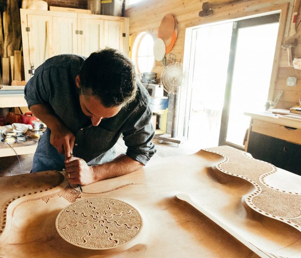 Caleb Woodard carving wood