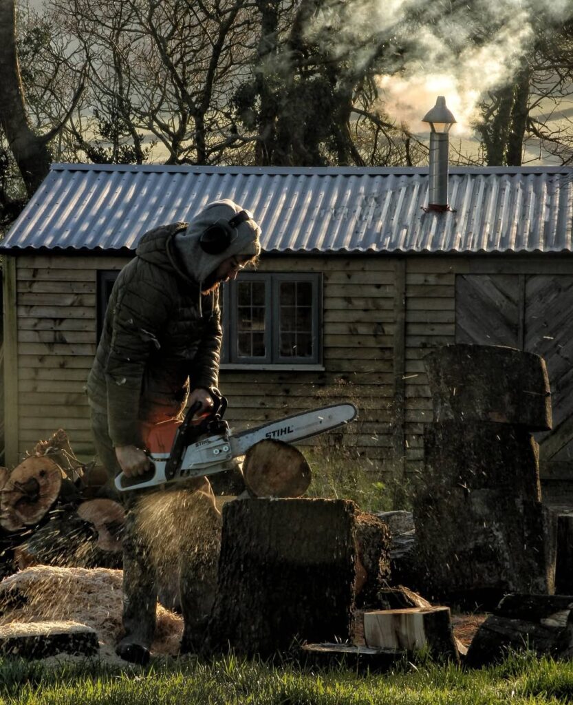 Dominic Pearce cutting logs