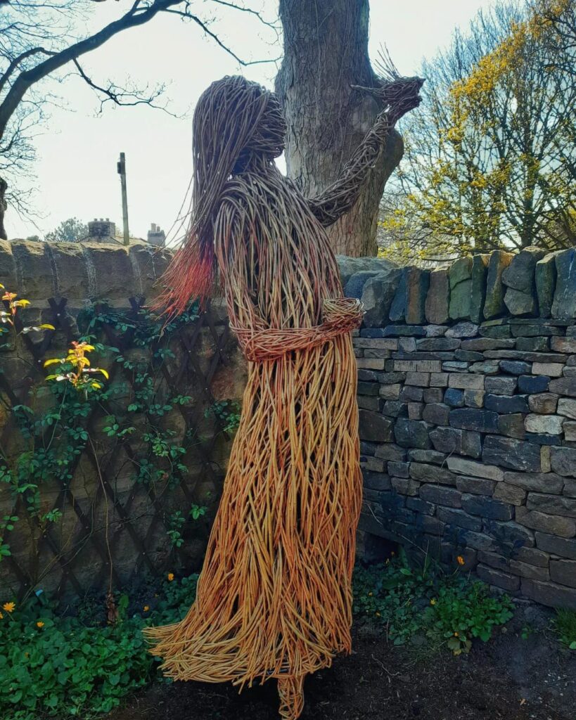 Willow sculpture - girl with nest and bird