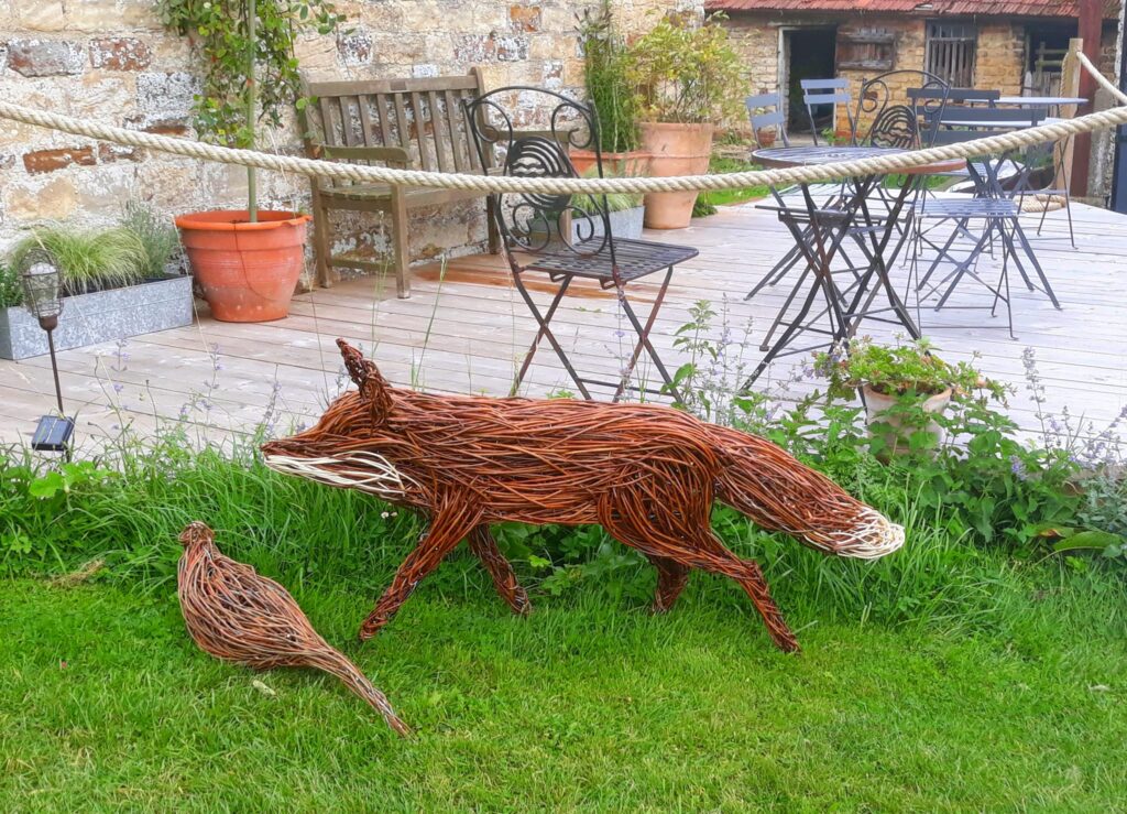 Willow fox and bird sculptures